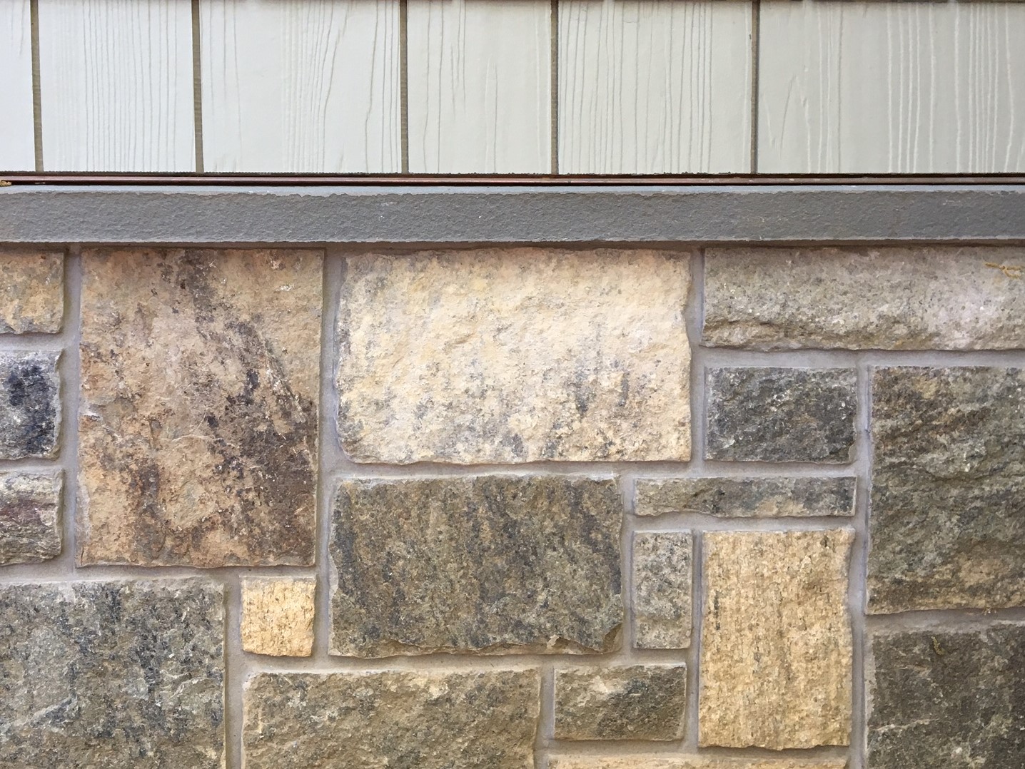natural facing real stone veneer installed on a water table with a sill