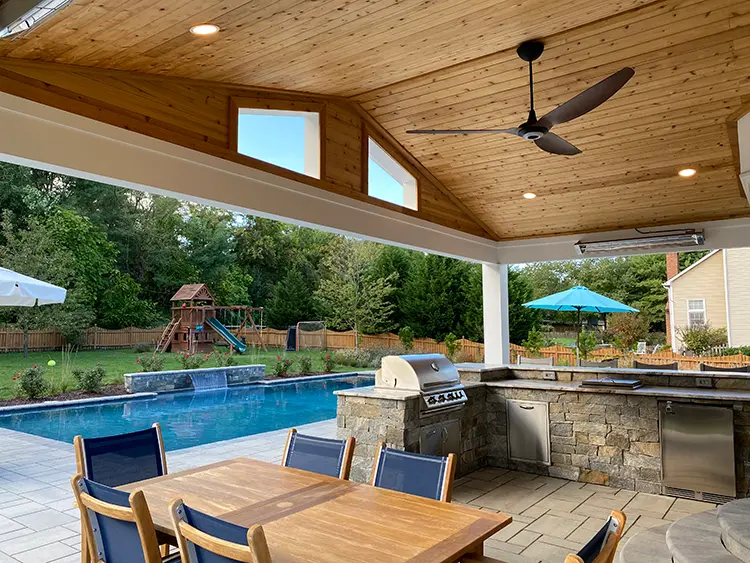 Ocean Blue Ledgestone natural stone veneer installed on an outdoor kitchen and pool water feature