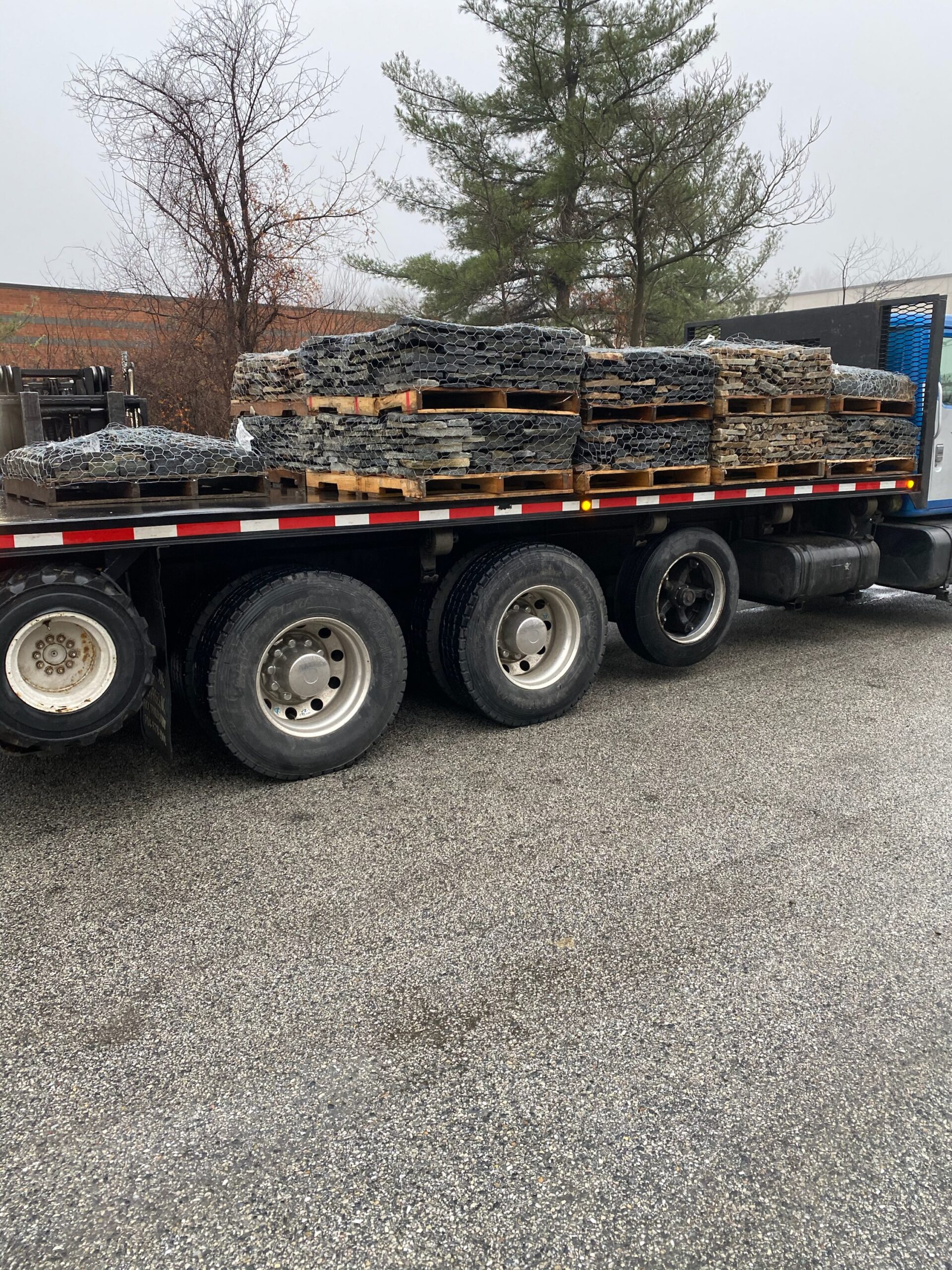 Natural stone veneer loaded onto a flatbed truck for delivery
