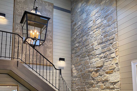 Custom Natural Facing stone veneer blend installed as an accent wall near a stairway