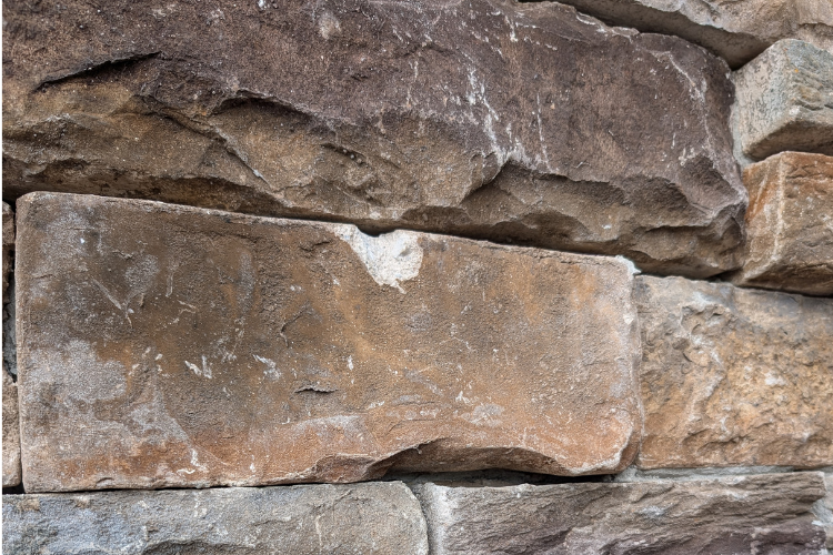 image showing a chip in the stone and durability issues of manufactured stone veneer